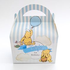 a blue and white striped box with winnie the pooh on it, holding a balloon