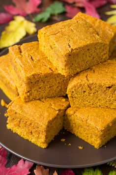 several pieces of cornbread on a plate with autumn leaves in the backgroud