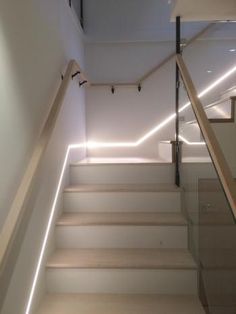 the stairs are illuminated with lights in this modern home