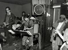 a group of people playing instruments in a room