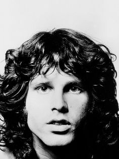 a black and white photo of a man with curly hair