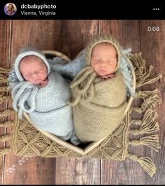 two newborn babies are in a heart shaped basket