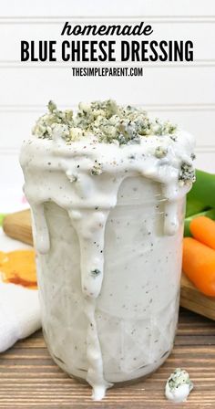 homemade blue cheese dressing in a jar with carrots and celery on the side