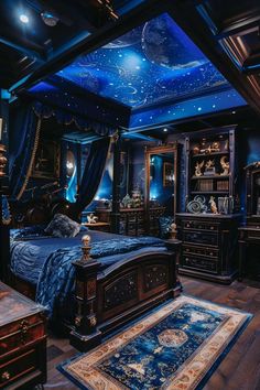 a bed room with a large bed covered in blue sheets and stars on the ceiling