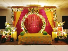 a decorated stage set up with flowers and candles for a wedding or other function event