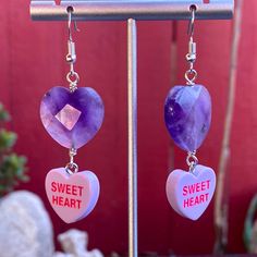 Gemstones are genuine amethyst metal is stainless steel earring wires are hypoallergenic Purple Double Heart Charm Jewelry, Purple Metal Earrings For Gift, Nickel-free Dangle Jewelry For Valentine's Day, Purple Metal Earrings As Gift, Purple Double Heart Jewelry With Heart Charm, Purple Pierced Metal Jewelry, Purple Metal Pierced Jewelry, Purple Amethyst Jewelry With Heart Charm, Purple Dangle Heart Earrings For Pierced Ears