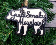 a wooden ornament hanging from a christmas tree with the words great smoky mountain on it