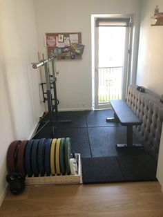 there is a bench and exercise equipment in the room