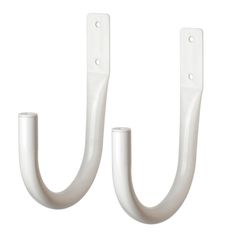 two white metal hooks hang from the wall