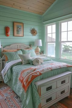 a bed sitting in a bedroom next to a window covered in green and orange blankets