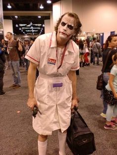 a man dressed up as the joker at an airport