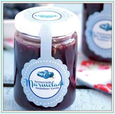 two jars of homemade blueberry jam on a table