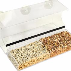 two different types of bird seed in a clear box on a white background with clippings