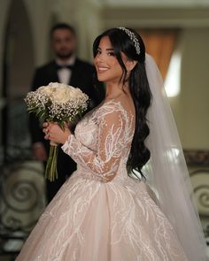 the bride is walking down the aisle with her bouquet