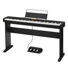 a black piano with a keyboard and mouse on it's side, in front of a white background