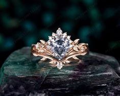 an engagement ring on top of a rock