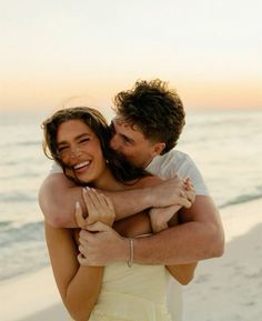 a man hugging a woman on the beach