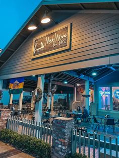 the outside of a restaurant with tables and chairs