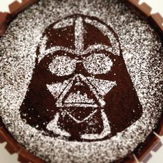 a star wars cake with chocolate frosting and sprinkles