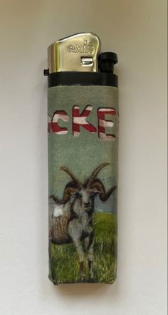 a lighter with an image of a goat on it's side and the words oke written in red