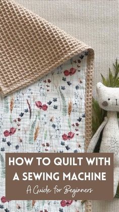 a teddy bear sitting on top of a quilt next to a sewing machine with the title how to quilt with a sewing machine