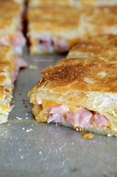 ham and cheese sandwich cut in half on a baking sheet, ready to be eaten