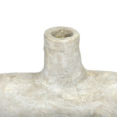 a white vase sitting on top of a stone block with a black handle and bottom part missing