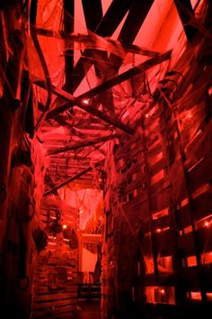 the inside of a building with red light coming from it's ceiling and walls