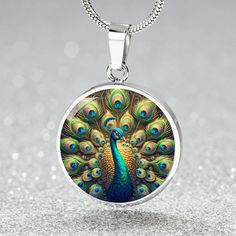 Admire the elegance of the Radiant Peacock Pendant Necklace, featuring a breathtaking stained glass style illustration of a peacock in full feather display. This intricate design showcases the peacock's vibrant plumage with stunning detail, capturing the essence of its regal beauty. Forged from premium surgical steel and available with a lavish 18k gold finish, this innovative jewelry boasts our exclusive design, handcrafted with care right here in the U.S.A by our dedicated team of skilled work Feather Display, Peacock Necklace, Peacock Pendant, Circle Pendant Necklace, Luxury Necklace, Glass Style, Working Moms, Circle Pendant, Showcase Design