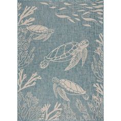 a blue rug with sea turtles and corals on it