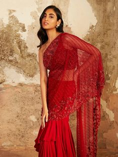 Red one shoulder floral pearl hand embellished blouse featuring a cut out back, paired with a layered georgette Saree with an attached hand embellished drape.From Shloka Khialani 's Elysium collection. DELIVERY TIMEPlease allow 1 week for your outfit to arrive. FABRIC DETAILSGeorgette, net, crepe Professional cleaning only. Shloka Khialani, Blouse Yoke, Georgette Skirt, Drape Saree, Embellished Blouse, Georgette Saree, Indian Attire, Fancy Sarees, Out Back