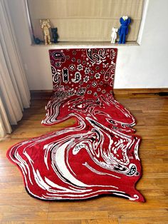 a red rug on the floor in front of a window