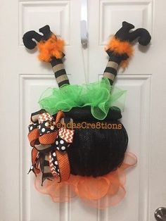 a door decorated for halloween with pumpkins and witch hats on the front doorsill