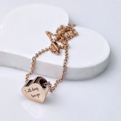 there is a heart shaped pendant on a chain that says, you should be loved