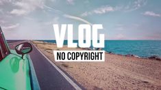 a green car driving down a road next to the ocean with words vlog no copyright