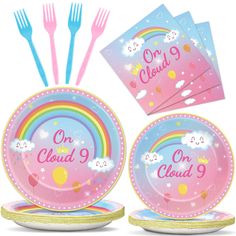 a set of pink plates with rainbows and clouds on them