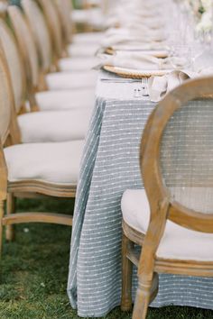 the table is set with white and blue linens