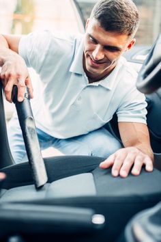 a man sitting in the driver's seat of a car