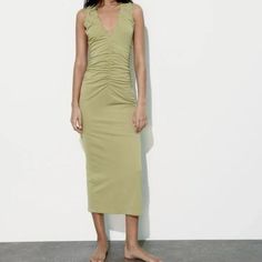 Dress Made Of Knit Fabric. Sleeveless With V-Neckline And Ruffle Detail. Hidden In-Seam Zip Closure. Apple Green Chic Yellow Stretch Sleeveless Dress, Green Stretch V-neck Sleeveless Dress, Green V-neck Stretch Sleeveless Dress, Green V-neck Sleeveless Stretch Dress, Casual Sleeveless V-neck Ruched Dress, Stretch V-neck Midi Dress With Ruffles, V-neck Stretch Sleeveless Dress For Spring, Sleeveless V-neck Stretch Dress For Spring, V-neck Sleeveless Stretch Dress For Spring