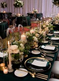 a long table is set with place settings and candles