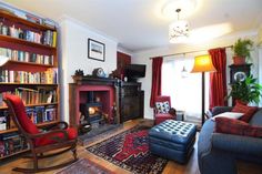 a living room filled with furniture and a fire place