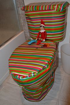 the elf is sitting on the toilet seat