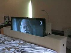 a bed with a television on top of it