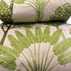 two pillows with green leaves on them