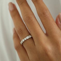 a woman's hand with a diamond ring on it