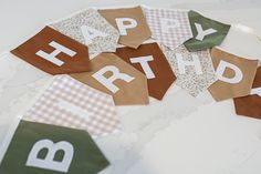 a birthday banner with the word happy written on it and some bunting around it