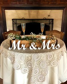 a table topped with a wooden mr and mrs sign