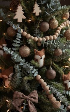 a christmas tree with ornaments on it and a fox decoration hanging from the top right