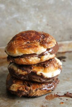 a stack of chocolate covered pastries sitting on top of each other