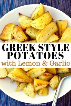 greek style potatoes with lemon and garlic in a white bowl on a blue wooden table